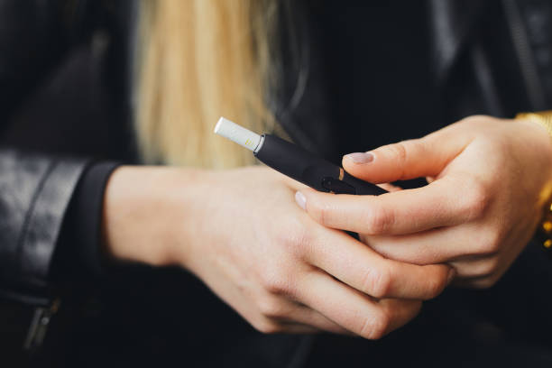 Close up electronic cigarette with case and blur girl on background